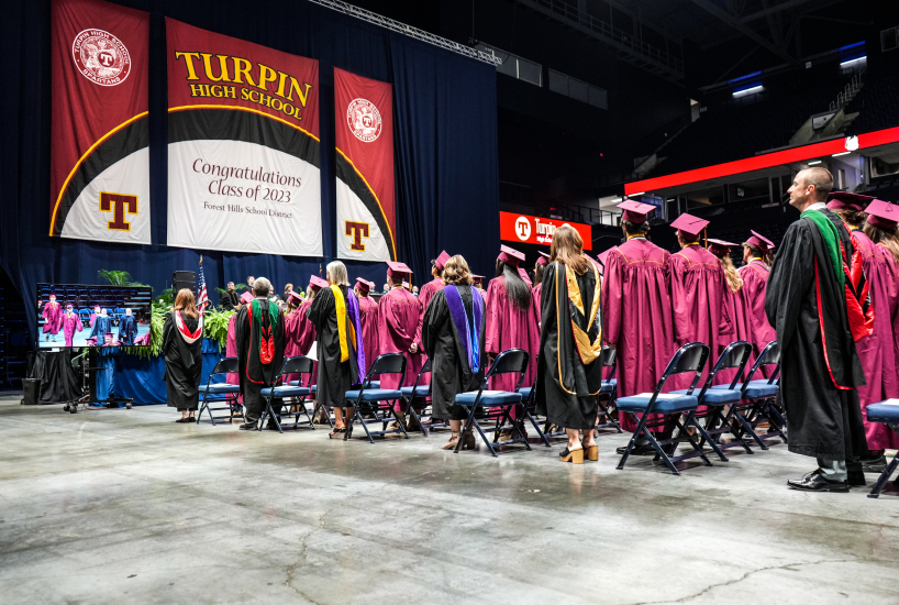 The Class of 2023 stands during graduation at the Cintas Center